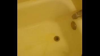 Urinating unto the bathtub