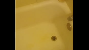 Urinating unto the bathtub