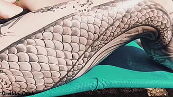 Tattooed horny brunette with big boobs sunbathing in the yard and rubbing sunscreen on her tits