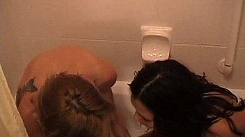 Two wet chicks playing bubbles naked in a hotel party