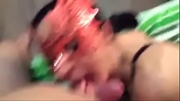 Couple in masks in front a camera