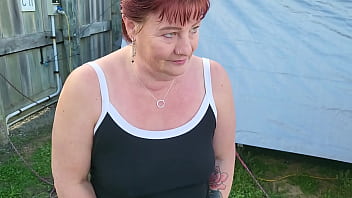 Trashy milf slut pees on the grass in front of other campers at the beach