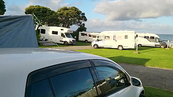 Trashy milf slut pees on the grass in front of other campers at the beach