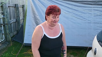 Trashy milf slut pees on the grass in front of other campers at the beach