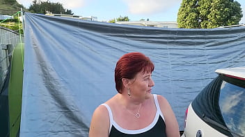 Trashy milf slut pees on the grass in front of other campers at the beach