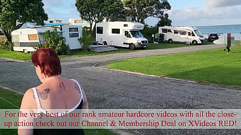 Trashy milf slut pees on the grass in front of other campers at the beach