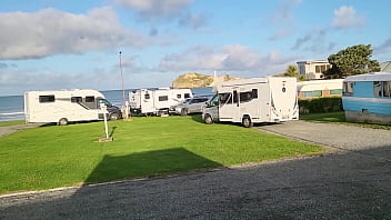 Trashy milf slut pees on the grass in front of other campers at the beach