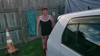 Trashy milf slut pees on the grass in front of other campers at the beach