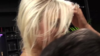 A blonde stripper with big boobs wearing lingerie and fishnet stockings gets it on with a