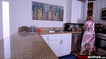 Redhead housewife cooks her dear boy breakfast