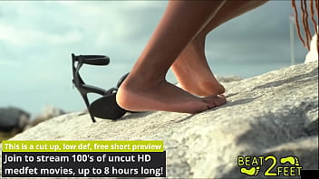 Giggles' feet love rubbing all over a giant hot rock at the beach on beat2feetcom