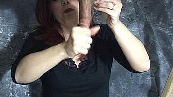 Mistress masturbates man's cock via gloryhole