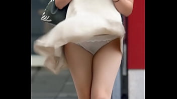 Attractive chinese looking woman got upskirt by the wind
