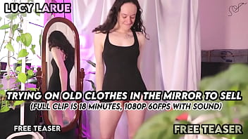 Trying on old clothes in the mirror to sell