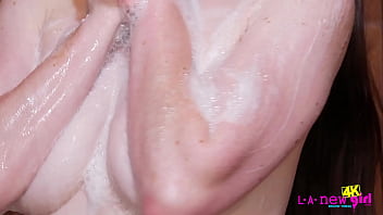 Beautiful brunette teen washes her body