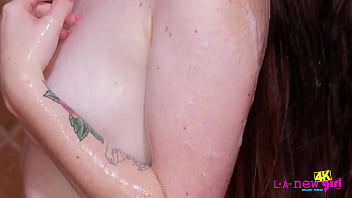 Beautiful brunette teen washes her body