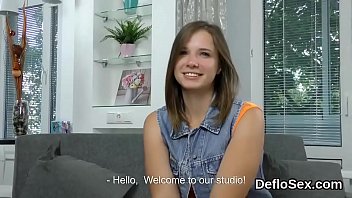 Cute semi nude beauty fondles her stretched hymen in close up