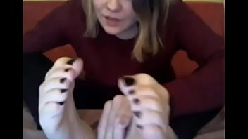 Webcam model in sweatshirt suck her own toes