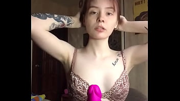 Rubs her tits on a rubber dick