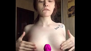 Rubs her tits on a rubber dick