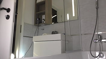 Sexy and horny tight pussy brunette slut in the bath shows her legs and what is under her mini skirt