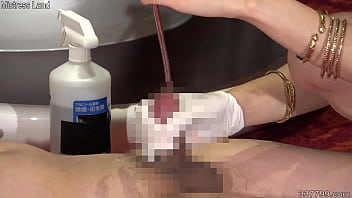 Japanese dominatrix shoves a cotton swab into a slave's urethra Japanese dominatrix shoves a cotton swab into a slave's urethra