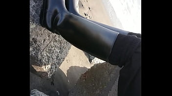 Fetish rubber boots at beach