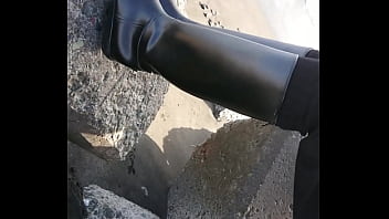 Fetish rubber boots at beach