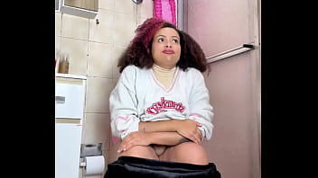Chubby girl can't stop farting in toilet with belly ache