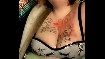 Mature busty with tattoos on her tits dances weird