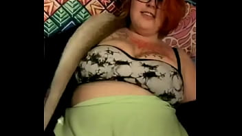 Mature busty with tattoos on her tits dances weird