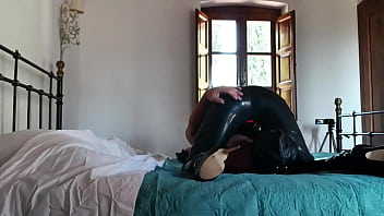 Laura on heels sexy milf 2023 in condom catsuit and high heels is throat fucked and creampied