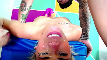 Blonde gets an exaggerated throat fuck on upsidedow