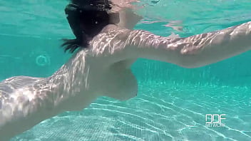 Natural tits superstar teases with cleavage in pool