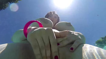 Natural tits superstar teases with cleavage in pool