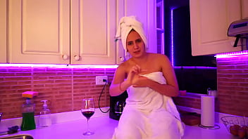 This girl masturbates in kitchen