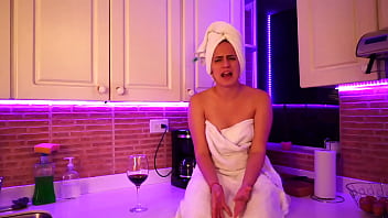 This girl masturbates in kitchen