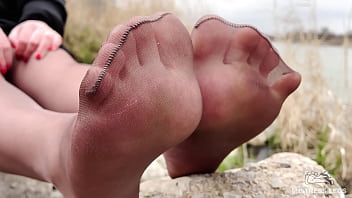 Cute soles and toes in tan tights outdoor