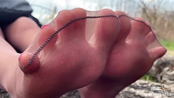 Cute soles and toes in tan tights outdoor