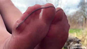 Cute soles and toes in tan tights outdoor