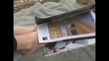 Flipping through magazine with feet