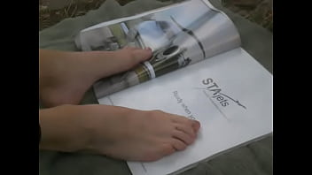 Flipping through magazine with feet