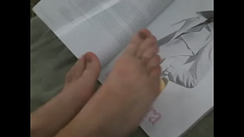 Flipping through magazine with feet