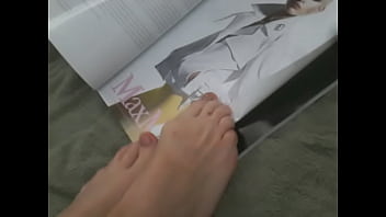 Flipping through magazine with feet