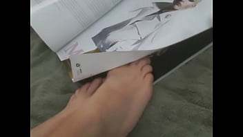 Flipping through magazine with feet