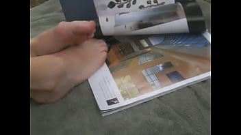 Flipping through magazine with feet