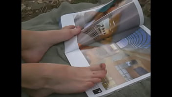 Flipping through magazine with feet