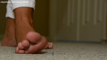 Giant girl crushing tiny man with cute bare foot