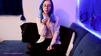 Emo punk girl sucks on a popsicle