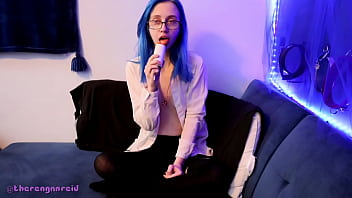 Emo punk girl sucks on a popsicle